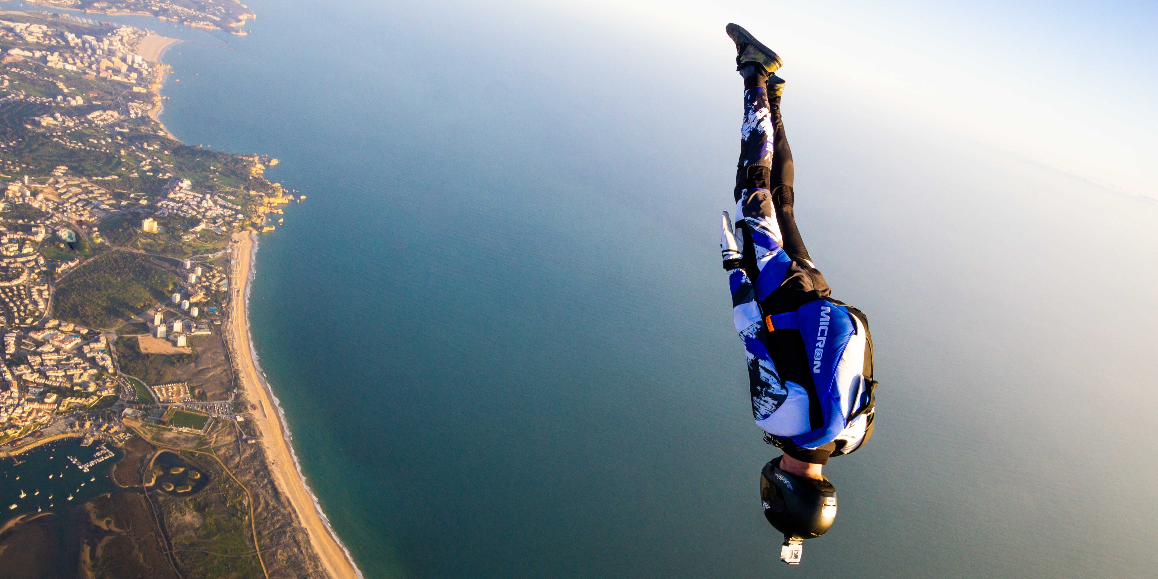 Person skydiving over Alvor in southern Portugal